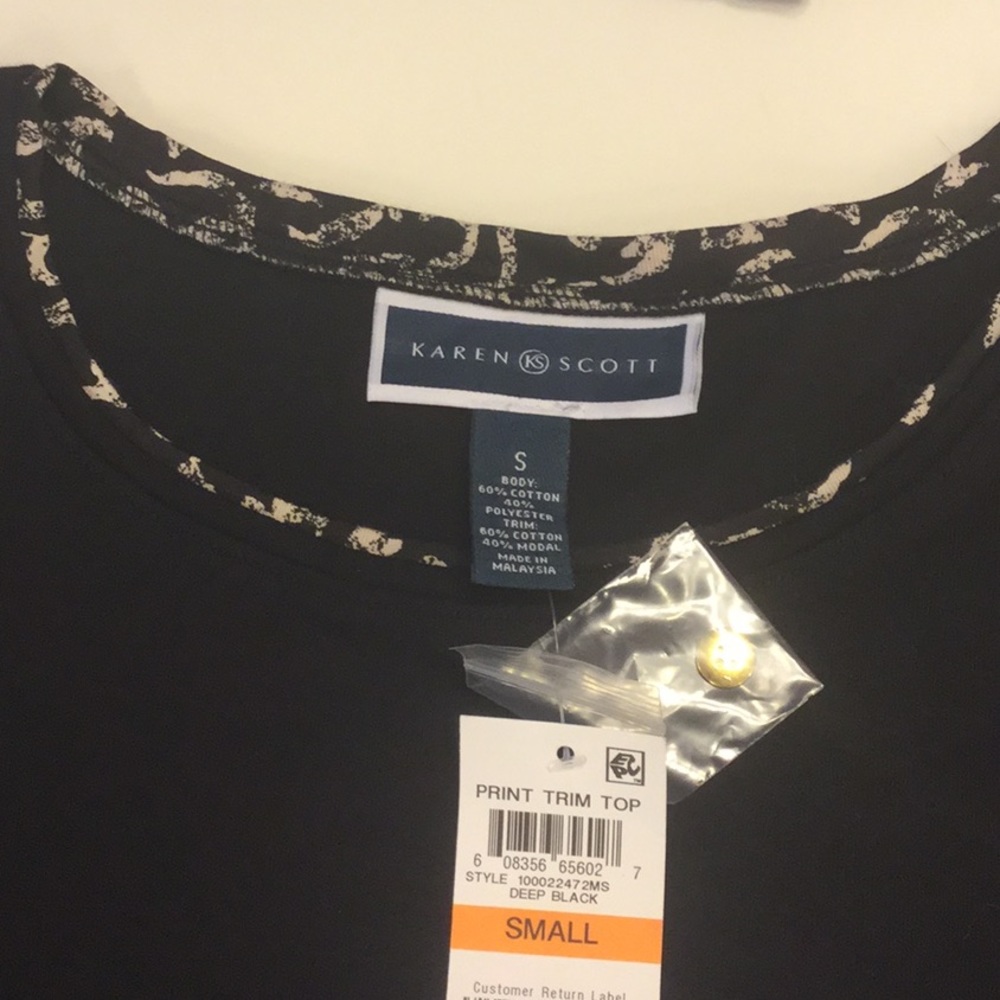 Karen Scott black top with decorative trim.